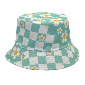 Detail of mint green checkerboard bucket hat featuring daisy floral print and cotton texture