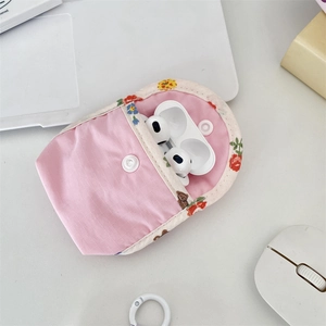 Detailed view of pink floral bear earphone case with snap closure and soft fabric texture