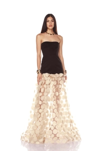 Detailed view of the layered white polka dot mesh skirt on an elegant black evening gown