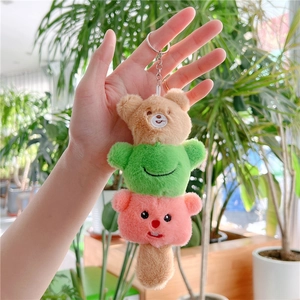 Close-up of cute plush beaver key chain with stacked colorful animal pom-pom design
