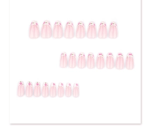 Detail of 24 almond-shaped press-on nails featuring pink rose and white lace floral patterns