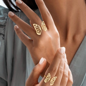 Close-up of elegant hollow butterfly ring in gold finish worn on finger