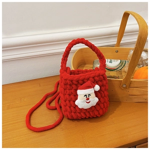 Close-up of handmade red knitted Christmas bag featuring a 3D Santa Claus decoration