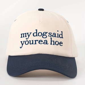 Detailed close-up of navy blue slogan embroidery on a beige cotton baseball cap