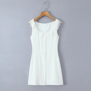Close-up of white lace trim collar and button front detail on a sleeveless mini dress