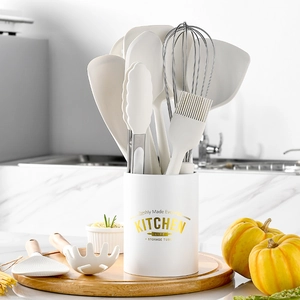 12-piece white silicone kitchen utensil set with wooden handles in a storage bucket