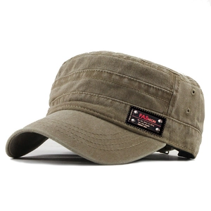 Detail of vintage washed cotton flat top military cap with a leather fashion patch