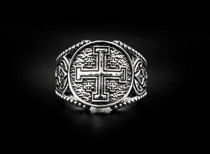 Detail of vintage polished stainless steel ring featuring an embossed Jerusalem cross