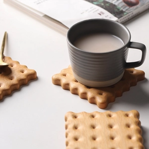 Detailed view of walnut biscuit-shaped wooden coaster for thermal insulation and tea cups