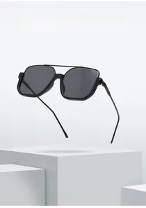 Detail of square black sunglasses with double bridge design on a geometric stand
