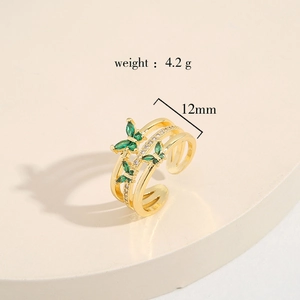 Detail of 12mm wide gold brass ring with two butterflies and green zircon stones