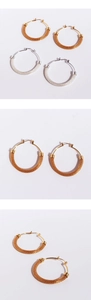 Detailed macro view of large woven mesh metal hoop earrings in silver and gold finishes