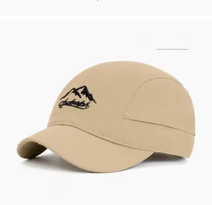 Detail showing khaki soft-top baseball cap with black mountain embroidery and short brim