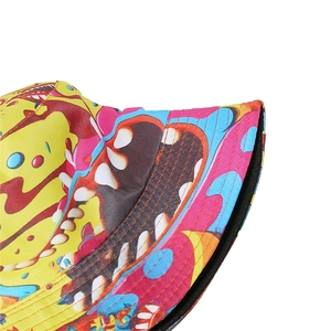 Detailed close-up of double-sided bucket hat with colorful monster graffiti patterns