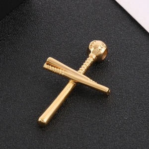 Macro shot of 18K gold plated baseball cross pendant on textured black background