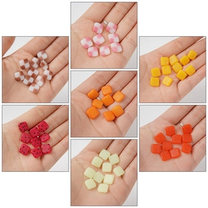 Miniature PVC fruit slices and colorful checkered resin charms for DIY cake crafts