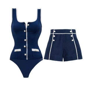 Navy blue two-piece swimsuit set with white piping and vintage buttons on a white background