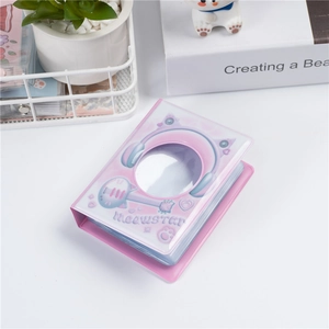 Pink 3-inch mini photo album with cute cat design on desk with plant and book