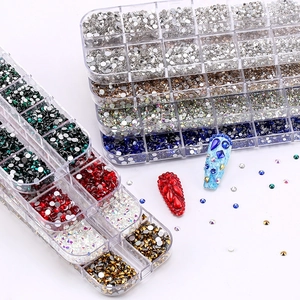 Multi-colored nail art rhinestones set in a 12-grid organizer box for DIY decoration