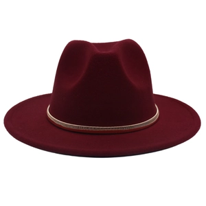 Detail of the golden metallic braided band on a burgundy wool fedora felt hat