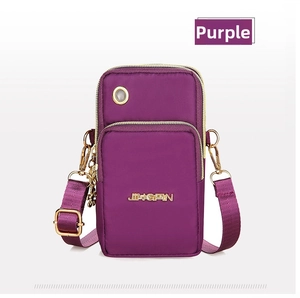 Detail of purple multi-layer mini crossbody bag with three zippers and headphone port