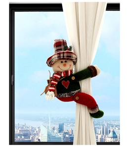 Close-up of a festive snowman curtain tieback with red plaid hat and scarf detail