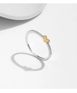 Close-up of a s925 silver ring featuring a golden heart inlay and sparkling pavé diamonds