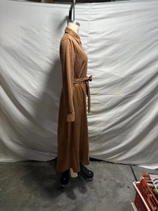 Side view of brown faux suede shirt dress with waist tie belt and button closure