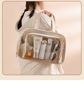 Model showing a cream travel toiletry bag with breathable mesh and PVC waterproof window