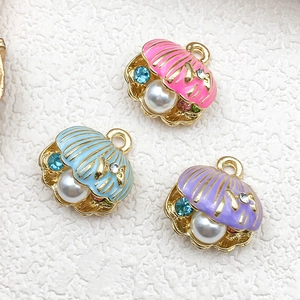 Enamel sea shell pendants with pearls and rhinestones in pink, blue, and purple colors