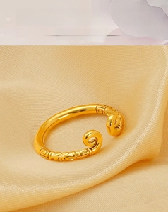 Macro shot of 18k gold plated stainless steel ring with intricate vintage engraving details