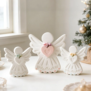 Three-piece set of white angel figurines with heart details and floral textures
