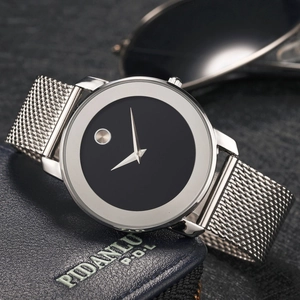 Detail of silver mesh band watch with black dial and signature dot on blue leather
