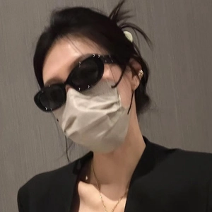 Y2K style black oval cat-eye sunglasses with wide frames on a female model