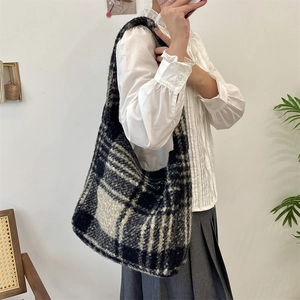 Close-up of black and white plaid wool tote bag showing thick fuzzy texture and large capacity