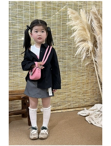 Pink mini crossbody bag styled with black jacket and grey skirt for girls