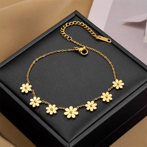 Rose gold daisy flower bracelet for women with six floral charms on a sleek cable chain