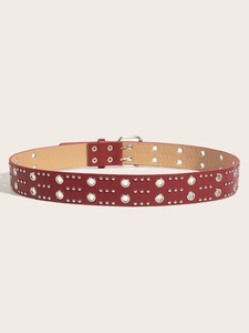 Detailed view of red leather punk belt with silver double metal grommets and rivets