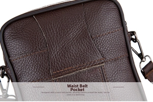 Detail showing the leather belt loop and metal D-ring attachment on a brown crossbody bag