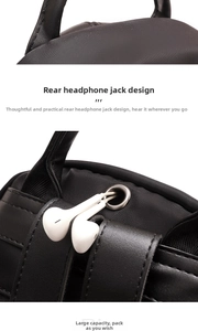 Detail view of the headphone port design on a durable black oxford fabric backpack