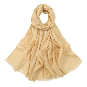 Solid beige slub cotton scarf for women featuring delicate fringe edges on white background