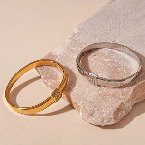 Minimalist geometric bangle with pavé diamonds in gold and silver finish on stone