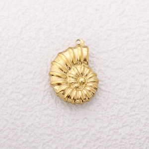 Macro detail of 18K gold plated conch shell pendant with jewelry loop on white surface