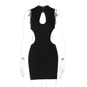 Detail of black cut-out dress featuring halter neck and butterfly metal ornament