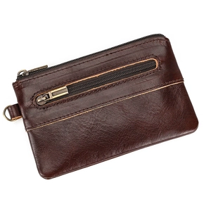 Detail of vintage dark brown genuine leather coin purse with double bronze metal zippers