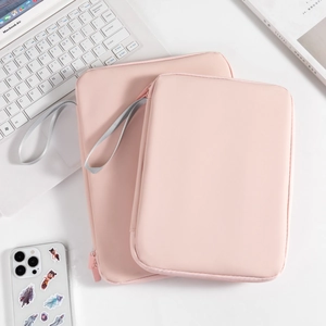 Waterproof pink PU laptop sleeve set with portable lanyard for 11 inch iPad on a white desk