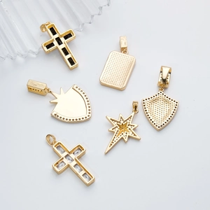 Gold cross and shield pendant necklaces with star motifs on a clean white backdrop