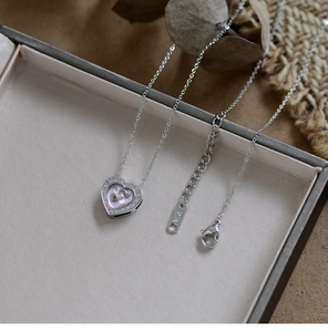 Close-up of heart pendant necklace with K14 gold mark and lobster clasp detail