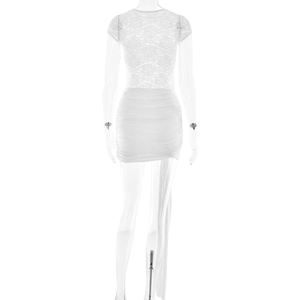 Detail of white lace mini dress featuring floral patterns and pleated hem design