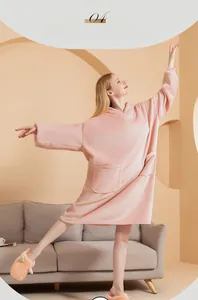 Pink oversized flannel hooded blanket with soft fleece texture and large front pocket